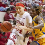 
              Indiana guard Sara Scalia (14) drives the ball against the defense of Morehead State guard Veronica Charles during the second half of an NCAA college basketball game, Sunday, Dec. 18, 2022, in Bloomington, Ind. (AP Photo/Doug McSchooler)
            