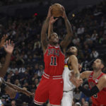 
              Chicago Bulls forward DeMar DeRozan (11) goes up to the basket against Minnesota Timberwolves forward Kyle Anderson, second from right, during the first half of an NBA basketball game Sunday, Dec. 18, 2022, in Minneapolis. (AP Photo/Stacy Bengs)
            