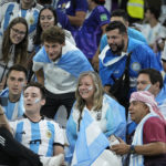 
              Fans of Argentina watch on a mobile screen the soccer match between Croatia and Brazil prior the start of the World Cup quarterfinal soccer match between the Netherlands and Argentina, at the Lusail Stadium in Lusail, Qatar, Friday, Dec. 9, 2022. (AP Photo/Jorge Saenz)
            