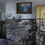 
              A line on a wall marks the mud level reached inside a home a day after a rain-weakened hillside collapsed and brought waves of mud over homes and a sports field, in the La Gasca neighborhood of Quito, Ecuador, on Feb. 2, 2022. (AP Photo/Dolores Ochoa)
            