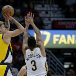 
              Indiana Pacers guard Chris Duarte, left, shoots against New Orleans Pelicans guard CJ McCollum, second from left, in the first half of an NBA basketball game in New Orleans, Monday, Dec. 26, 2022. (AP Photo/Matthew Hinton)
            