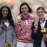 
              FILE - Russia's Natalya Antyukh, middle, holds the gold medal, United States' Lashinda Demus, left, the silver medal and Czech Republic's Zuzana Hejnova, the bronze medal during a ceremony for the women's 400-meter hurdles in the Olympic Stadium at the 2012 Summer Olympics, London, Thursday, Aug. 9, 2012. Russian 400-meter hurdler Natalya Antyukh will lose her gold medal from the 2012 London Games due to doping, putting American Lashinda Demus in position to be named the champion more than a decade after the race. (AP Photo/Matt Slocum, FIle)
            
