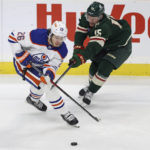 
              Edmonton Oilers center Mattias Janmark (26) and Minnesota Wild center Mason Shaw (15) go after the puck during the first period of an NHL hockey game Thursday, Dec. 1, 2022, in St. Paul, Minn. (AP Photo/Stacy Bengs)
            