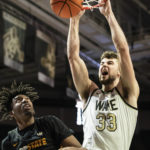 
              Wake Forest forward Matthew Marsh (33) dunks over Appalachian State forward Justin Abson (21) in the first half of an NCAA college basketball game on Wednesday, Dec. 14, 2022, at Joel Coliseum in Winston-Salem, N.C. (Allison Lee Isley/The Winston-Salem Journal via AP)
            