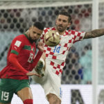 
              Morocco's Youssef En-Nesyri, left, and Croatia's Marko Livaja fight for the ball during the World Cup third-place playoff soccer match between Croatia and Morocco at Khalifa International Stadium in Doha, Qatar, Friday, Dec. 16, 2022. (AP Photo/Thanassis Stavrakis)
            