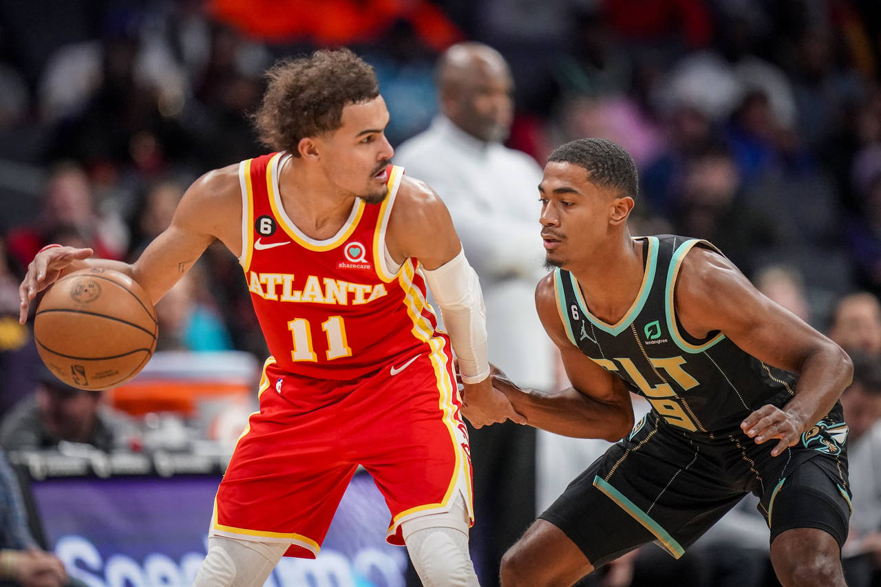 Atlanta Hawks guard Trae Young (11) is guarded by Charlotte Hornets guard Theo Maledon (9) during t...