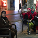 
              Morocco fans sit on street benches during celebrations in Barcelona, Spain, Tuesday, Dec. 6, 2022. Morocco beat Spain on penalties in a round of 16 World Cup soccer tournament in Qatar. (AP Photo/Pau de la Calle)
            