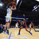 
              Golden State Warriors' Ty Jerome (10) shoots over New York Knicks' Miles McBride (2) during the first half of an NBA basketball game Tuesday, Dec. 20, 2022, in New York. (AP Photo/Frank Franklin II)
            