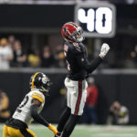 
              Atlanta Falcons wide receiver Drake London (5) misses a pass against Pittsburgh Steelers cornerback James Pierre (42) during the first half of an NFL football game, Sunday, Dec. 4, 2022, in Atlanta. (AP Photo/Brynn Anderson)
            