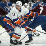 
              New York Islanders left wing Zach Parise, left, jostles for position with Colorado Avalanche defenseman Devon Toews in the second period of an NHL hockey game, Monday, Dec. 19, 2022, in Denver. (AP Photo/David Zalubowski)
            