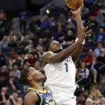 
              Minnesota Timberwolves guard Anthony Edwards (1) shoots on Indiana Pacers guard Bennedict Mathurin (00) in the first quarter of an NBA basketball game Wednesday, Dec. 7, 2022, in Minneapolis. (AP Photo/Andy Clayton-King)
            