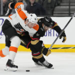 
              Philadelphia Flyers defenseman Justin Braun (61) and Vegas Golden Knights center Chandler Stephenson (20) battle for the puck during the second period of an NHL hockey game Friday, Dec. 9, 2022, in Las Vegas. (AP Photo/John Locher)
            