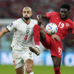 
              Morocco's Sofyan Amrabat, left, and Canada's Alphonso Davies, right, challenge for the ball during the World Cup group F soccer match between Canada and Morocco at the Al Thumama Stadium in Doha , Qatar, Thursday, Dec. 1, 2022. (AP Photo/Natacha Pisarenko)
            