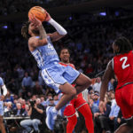 
              North Carolina guard R.J. Davis (4) shoots during the second half of an NCAA college basketball game against Ohio State in the CBS Sports Classic, Saturday, Dec. 17, 2022, in New York. The Tar Heels won 89-84 in overtime. (AP Photo/Julia Nikhinson)
            