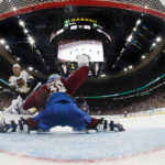 
              In this photo shot with a wide angle lens, Boston Bruins' David Pastrnak scores on Colorado Avalanche goaltender Pavel Francouz during the second period of an NHL hockey game against the Boston Bruins Saturday, Dec. 3, 2022, in Boston. (AP Photo/Winslow Townson)
            