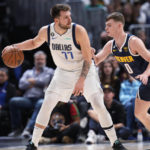 
              Dallas Mavericks guard Luka Doncic, left, looks to pass the ball as Denver Nuggets guard Christian Braun defends in the second half of an NBA basketball game Tuesday, Dec. 6, 2022, in Denver. (AP Photo/David Zalubowski)
            