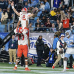 
              Clemson quarterback Cade Klubnik (2) celebrates after his touchdown with offensive lineman Mitchell Mayes (77) in the first half during the Atlantic Coast Conference championship NCAA college football game against North Carolina on Saturday, Dec. 3, 2022, in Charlotte, N.C. (AP Photo/Jacob Kupferman)
            