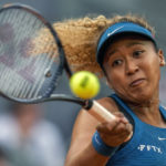 
              FILE - Naomi Osaka, of Japan, returns the ball against Sara Sorribes Tormo, of Spain, during their match at the Mutua Madrid Open tennis tournament in Madrid, Spain, Sunday, May 1, 2022. The bankruptcy of FTX and the arrest of its founder and former CEO are raising new questions about the role celebrity athletes such as Tom Brady, Steph Curry, Osaka and others played in lending legitimacy to the largely unregulated landscape of crypto, while also reframing the conversation about just how costly blind loyalty to favorite players or teams can be for the average fan. (AP Photo/Manu Fernandez, File)
            