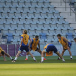 
              England players stretch during a training session at Al Wakrah Sports Complex on the eve of the Round of 16 World Cup soccer match between England and Senegal, in Al Wakarah, Qatar, Saturday, Dec. 3, 2022. (AP Photo/Abbie Parr)
            