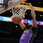 
              Los Angeles Lakers forward Anthony Davis (3) dunks during the first half of an NBA basketball game against the Denver Nuggets in Los Angeles, Friday, Dec. 16, 2022. (AP Photo/Ashley Landis)
            