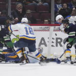 
              St. Louis Blues' Colton Parayko (55) clears the puck away after goalie Jordan Binnington stopped Vancouver Canucks' Curtis Lazar (20) during the third period of an NHL hockey game in Vancouver, British Columbia, on Monday, Dec. 19, 2022. (Darryl Dyck/The Canadian Press via AP)
            