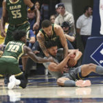 
              West Virginia forward Tre Mitchell, front right, is defended by UAB guard Jordan Walker (10) and forward KJ Buffen, back right, during the first half of an NCAA college basketball game in Morgantown, W.Va., Saturday, Dec. 10, 2022. (AP Photo/Kathleen Batten)
            