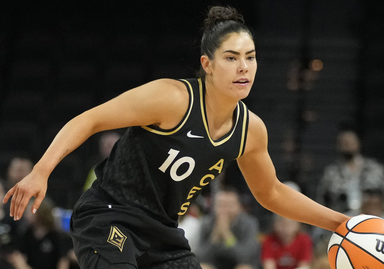 FILE - Las Vegas Aces' Kelsey Plum drives against the Dallas Wings during the second half of a WNBA...