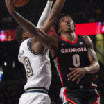 
              Georgia guard Terry Roberts scores against Georgia Tech guard Miles Kelly during the first half of an NCAA college basketball game Tuesday, Dec. 6, 2022, in Atlanta. (AP Photo/Hakim Wright Sr.)
            