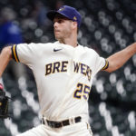 
              FILE - Milwaukee Brewers' Taylor Rogers throws during the eighth inning of a baseball game against the Arizona Diamondbacks, Oct. 3, 2022, in Milwaukee. Just minutes after Taylor insisted he and identical twin Tyler would never pull any pranks, his brother did just that as Taylor finished his introductory video call with the Giants to join the same San Francisco bullpen as Tyler. (AP Photo/Morry Gash, File)
            