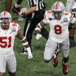 
              Ohio State defensive end Javontae Jean-Baptiste (8) and Ohio State defensive tackle Michael Hall Jr. (51) celebrate the sack on Georgia quarterback Stetson Bennett during the first half of the Peach Bowl NCAA college football semifinal playoff game, Saturday, Dec. 31, 2022, in Atlanta. (AP Photo/Brynn Anderson)
            