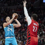 
              Charlotte Hornets center Mason Plumlee, left, shoots over Portland Trail Blazers center Jusuf Nurkic during the first half of an NBA basketball game in Portland, Ore., Monday, Dec. 26, 2022. (AP Photo/Craig Mitchelldyer)
            