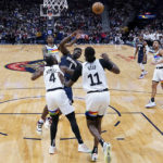 
              Minnesota Timberwolves guard Jaylen Nowell (4) and center Naz Reid (11) try to stop New Orleans Pelicans forward Zion Williamson (1) from getting to the basket in the first half of an NBA basketball game in New Orleans, Wednesday, Dec. 28, 2022. (AP Photo/Gerald Herbert)
            