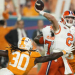 
              Clemson quarterback Cade Klubnik (2) passes under pressure from Tennessee defensive lineman Roman Harrison (30) during the first half of the Orange Bowl NCAA college football game, Friday, Dec. 30, 2022, in Miami Gardens, Fla. (AP Photo/Rebecca Blackwell)
            