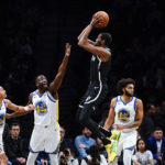 
              Golden State Warriors' Draymond Green (23) and Jordan Poole (3) defend a shot by Brooklyn Nets' Kevin Durant (7) during the first half of an NBA basketball game as teammate Anthony Lamb (40) watches Wednesday, Dec. 21, 2022 in New York. (AP Photo/Frank Franklin II)
            