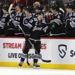 
              New Jersey Devils center Nico Hischier (13) is congratulated for his goal against the Chicago Blackhawks during the second period of an NHL hockey game Tuesday, Dec. 6, 2022, in Newark, N.J. (AP Photo/Noah K. Murray)
            