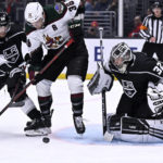 
              Arizona Coyotes right wing Christian Fischer, center, vies for the puck with Los Angeles Kings defenseman Sean Durzi, left, in front of goaltender Jonathan Quick during the third period of an NHL hockey game in Los Angeles, Thursday, Dec. 1, 2022. (AP Photo/Alex Gallardo)
            