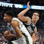 
              Milwaukee Bucks forward Giannis Antetokounmpo, left, gets past Dallas Mavericks center Dwight Powell, right, during the first quarter of an NBA basketball game in Dallas, Friday, Dec. 9, 2022. (AP Photo/LM Otero)
            