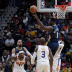 
              New Orleans Pelicans forward Zion Williamson (1) passes over Phoenix Suns guard Chris Paul (3) and center Jock Landale (11) in the first half of an NBA basketball game in New Orleans, Sunday, Dec. 11, 2022. (AP Photo/Gerald Herbert)
            
