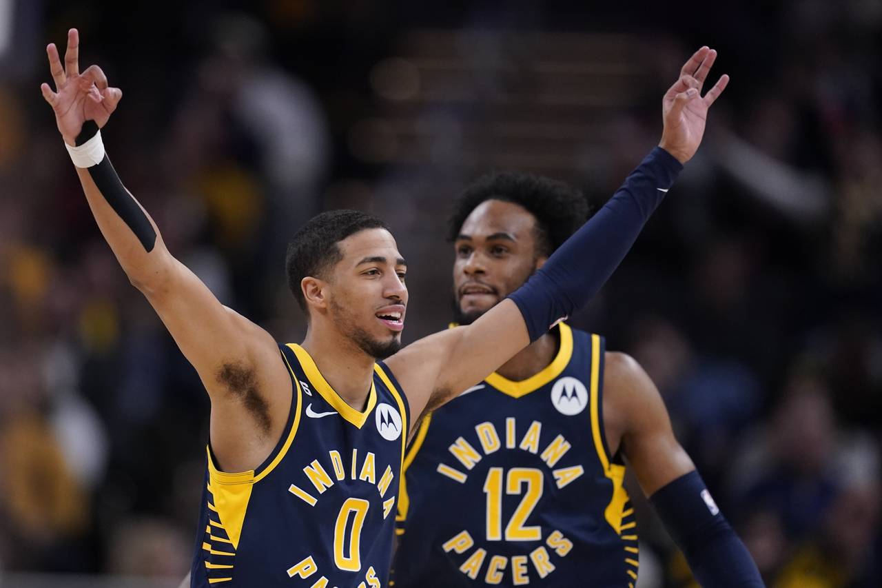 Indiana Pacers' Tyrese Haliburton (0) reacts after a 3-point basket by Buddy Hield during the secon...