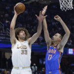 
              Cleveland Cavaliers center Robin Lopez (33) shoots against Oklahoma City Thunder forward Aleksej Pokusevski (17) during the first half of an NBA basketball game Saturday, Dec. 10, 2022, in Cleveland. (AP Photo/Ron Schwane)
            