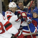 
              New Jersey Devils defenseman Ryan Graves (33) and New York Rangers defenseman Ryan Lindgren (55) fight during the first period of an NHL hockey game, Monday, Dec. 12, 2022, at Madison Square Garden in New York. (AP Photo/Mary Altaffer)
            