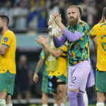 
              Australian players react to supporters following the World Cup round of 16 soccer match against Argentina at the Ahmad Bin Ali Stadium in Doha, Qatar, Sunday, Dec. 4, 2022. (AP Photo/Jorge Saenz)
            