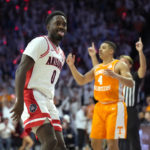 
              Arizona guard Courtney Ramey (0) reacts after scoring during the second half of an NCAA college basketball game against Tennessee, Saturday, Dec. 17, 2022, in Tucson, Ariz. Arizona won 75-70. (AP Photo/Rick Scuteri)
            