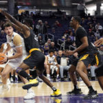 
              Northwestern forward Robbie Beran, left, looks to pass against Prairie View A&M forward Mckinley Harris during the second half of an NCAA college basketball game in Evanston, Ill., Sunday, Dec. 11, 2022. (AP Photo/Nam Y. Huh)
            