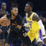 
              Cleveland Cavaliers guard Darius Garland (10) is defended by Los Angeles Lakers guard Dennis Schroder (17) during the first half of an NBA basketball game Tuesday, Dec. 6, 2022, in Cleveland. (AP Photo/Ron Schwane)
            