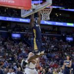 
              New Orleans Pelicans forward Zion Williamson (1) dunks against Denver Nuggets forward Aaron Gordon (50) in the first half of an NBA basketball game in New Orleans, Sunday, Dec. 4, 2022. (AP Photo/Matthew Hinton)
            