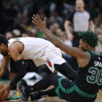 
              Miami Heat's Gabe Vincent (2) and Boston Celtics' Marcus Smart (36) compete for the ball during the first half of an NBA basketball game Friday, Dec. 2, 2022, in Boston. (AP Photo/Michael Dwyer)
            