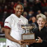 
              South Carolina forward Aliyah Boston, left, is presented with the Honda-Broderick Cup as the Collegiate Woman Athlete of the Year by Jenny Gilger before an NCAA college basketball game against Charleston Southern in Columbia, S.C., Sunday, Dec. 18, 2022. (AP Photo/Nell Redmond)
            