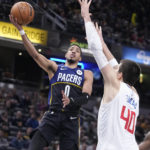 
              Indiana Pacers' Tyrese Haliburton (0) shoots over LA Clippers' Ivica Zubac (40) during the first half of an NBA basketball game, Saturday, Dec. 31, 2022, in Indianapolis. (AP Photo/Darron Cummings)
            
