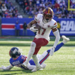 
              Washington Commanders' Terry McLaurin breaks a tackle to score a touchdown during the first half of an NFL football game against the New York Giants, Sunday, Dec. 4, 2022, in East Rutherford, N.J. (AP Photo/John Minchillo)
            